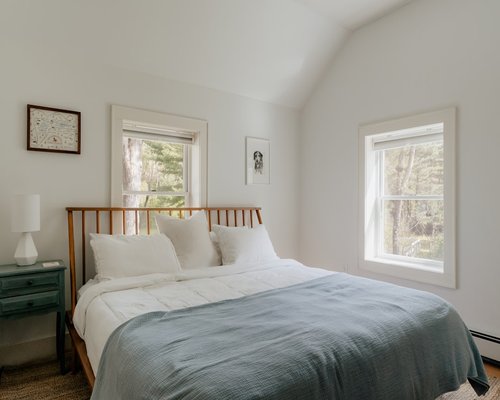 A comfortable bed with soft linens and natural light